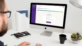 Man with a cup of coffee using Grant Thornton app