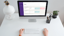 Computer on white desk with Grant Thornton application running